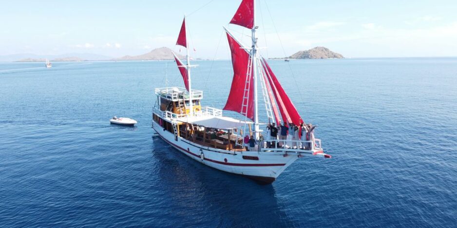 a boat with people on it sailing in the water