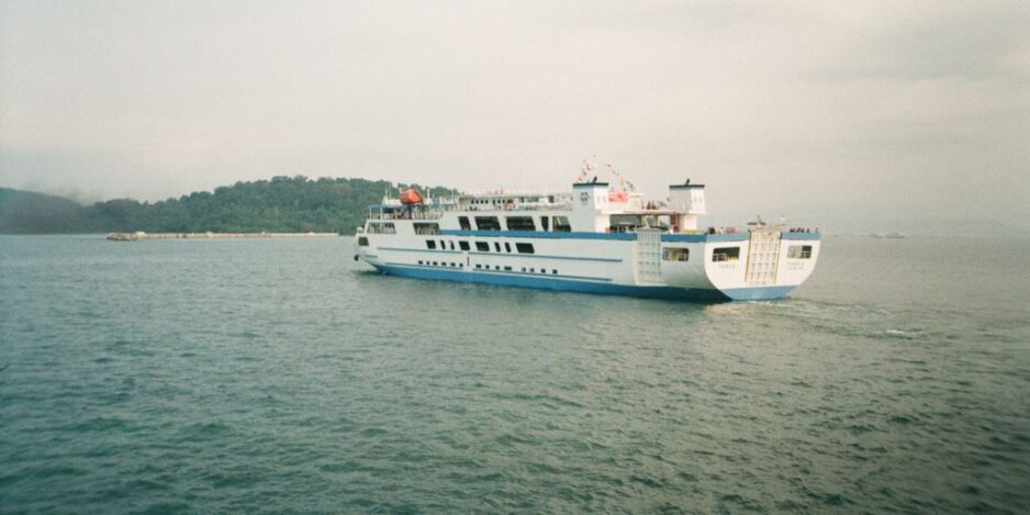 a large white and blue boat in a body of water