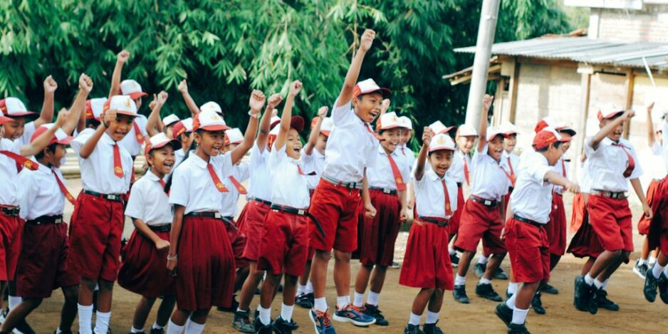 group of people in red and white uniform holding hands