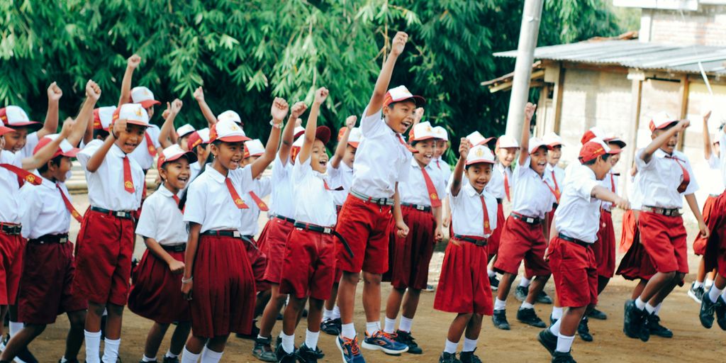 group of people in red and white uniform holding hands