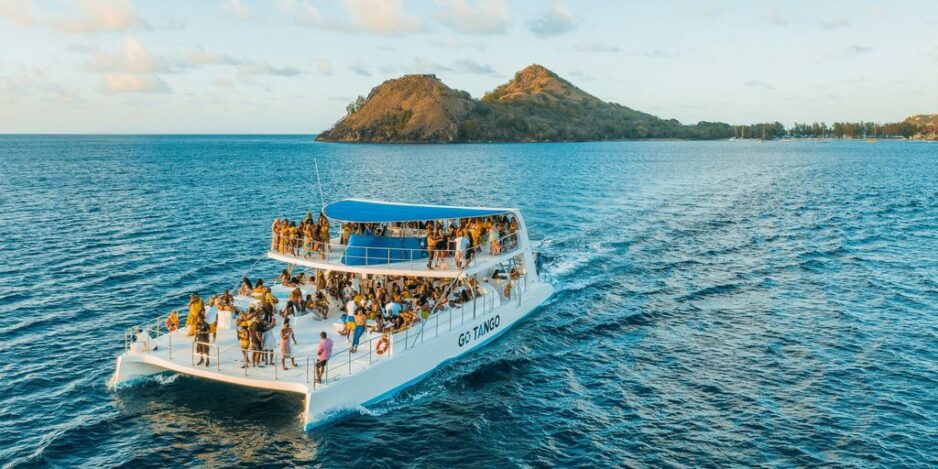 people riding on white boat on sea during daytime