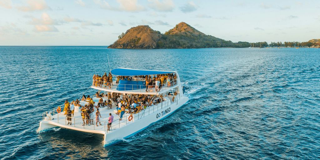 people riding on white boat on sea during daytime